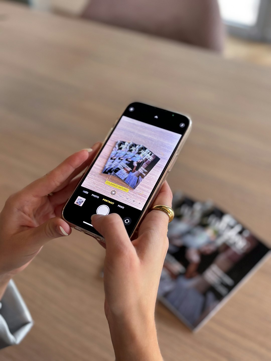 hands-holding-phone-taking-picture-of-photos-i-vodx05cfg